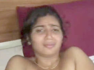 A well-endowed woman pleasures herself on the shore