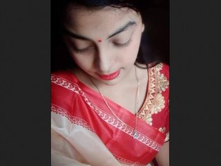 A stunning Asian woman of Bangladeshi descent provocatively displays her attractive physique