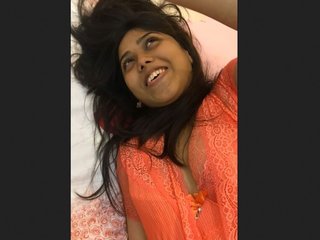 Indian girl pleasures herself while speaking and sucking her fingers