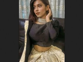 A seductive young woman tantalizes with her ample bosom