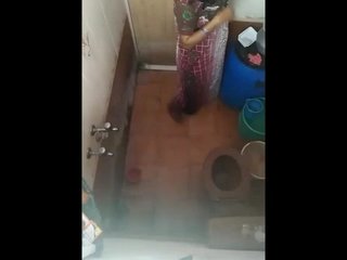 A Tamil wife from the south removes her pubic hair in the bath