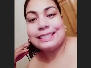 Indian woman takes bath and works with milk in tanker