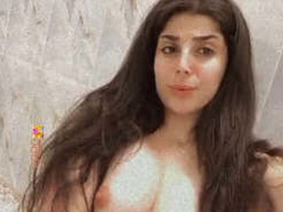 A stunning Pakistani beauty with large breasts and a revealing pussy performs