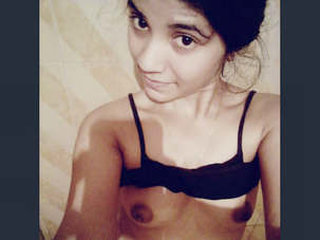 A charming girl displays her breasts