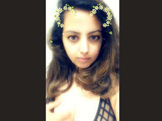A charming girl enjoys fondling her own breasts