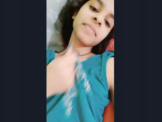 A charming Sri Lankan woman displays her breasts, intimate areas, and videos