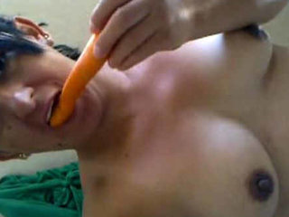 Arousing young amateur teen girl employs a carrot for her own gratification