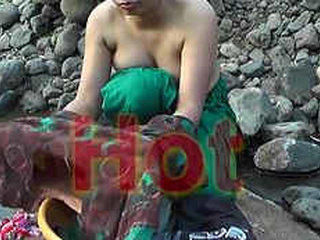 Young woman bares her body while bathing in the wilderness