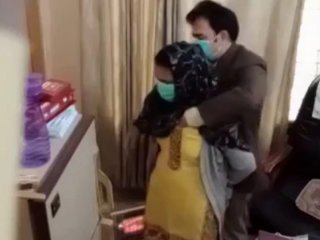 Doctor uses his hands to check a Pakistani woman's breasts