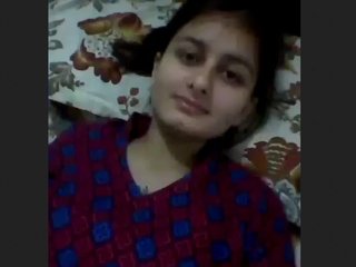 Girl in a suit pleasures herself with her hands