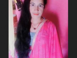 A beautiful Indian woman in traditional attire gets ready after bathing