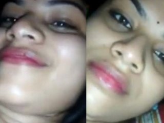 Friend of a beautiful wife with big breasts smiles in a video