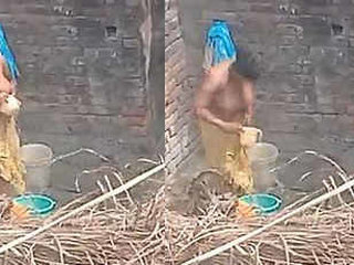 Indian aunty takes a bath in the open air
