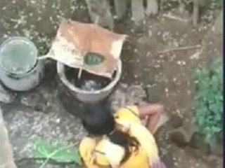 Girl from a rural area relieves herself outdoors