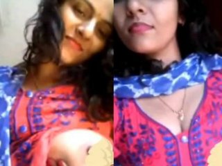 Bhabhi flaunts her big breasts and seductive curves in this steamy video